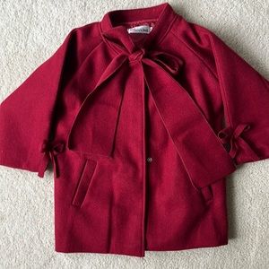 Burgundy and maroon colored pea coat, that snaps and ties in a bowl with a neck